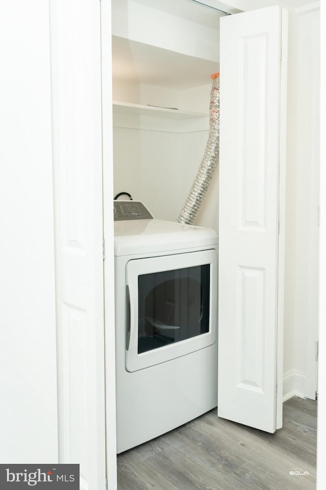 washroom with washer / clothes dryer and light hardwood / wood-style floors