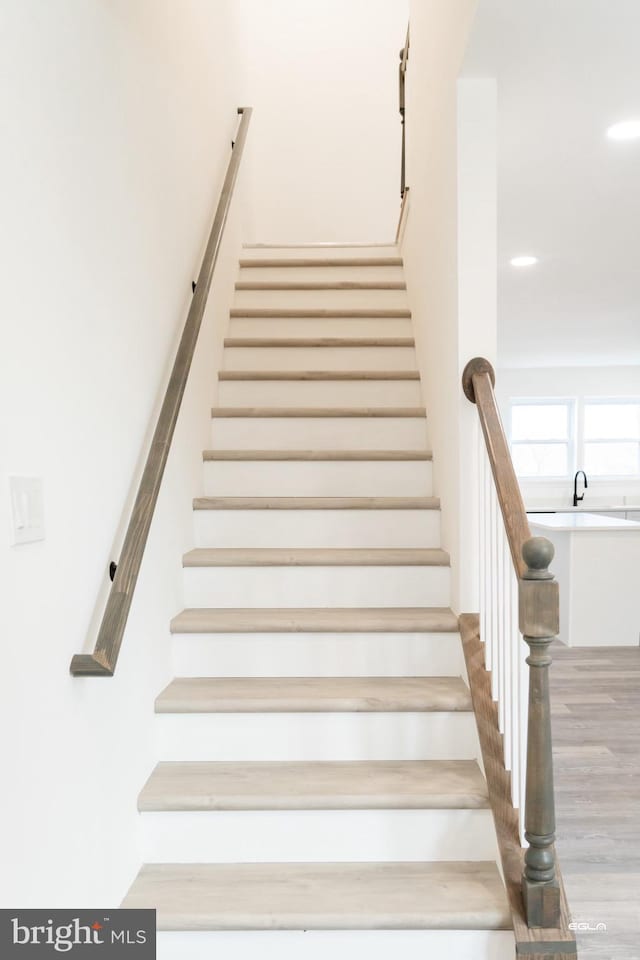 stairs with wood-type flooring