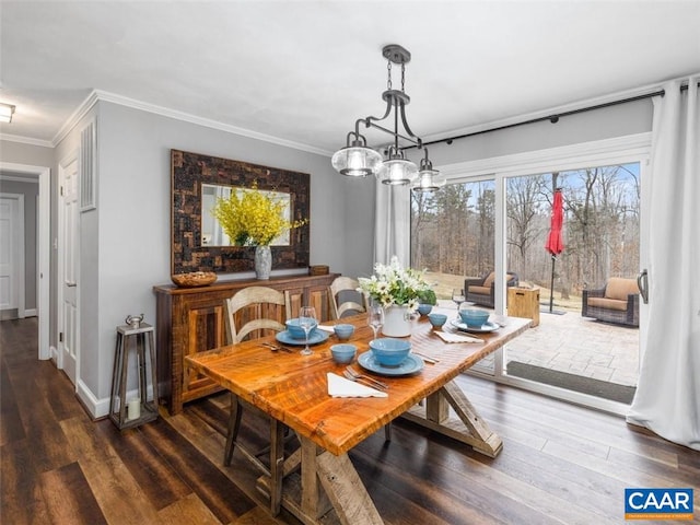 dining room with ornamental molding, dark wood-type flooring, and a notable chandelier