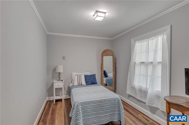 bedroom with dark wood-type flooring and ornamental molding