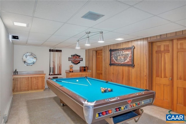 recreation room featuring wood walls, billiards, a baseboard radiator, light carpet, and a paneled ceiling