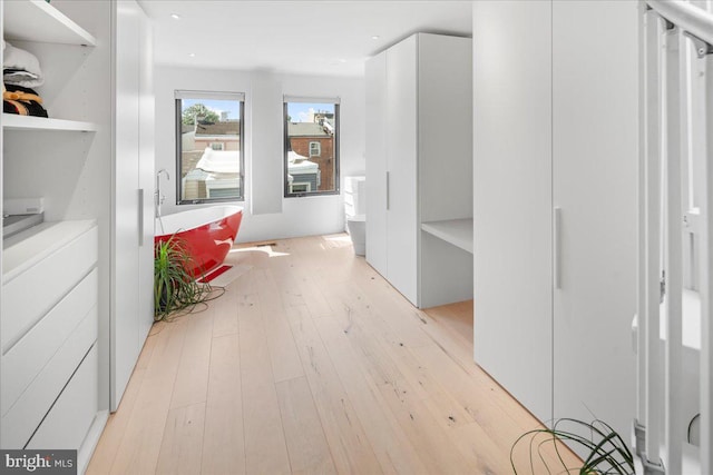 hall with light hardwood / wood-style floors