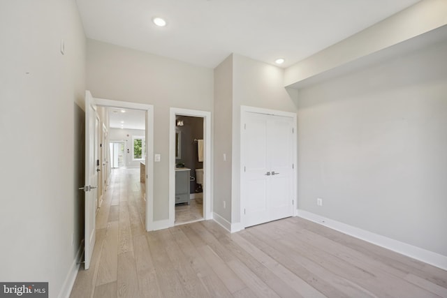 unfurnished bedroom with light hardwood / wood-style floors and a closet