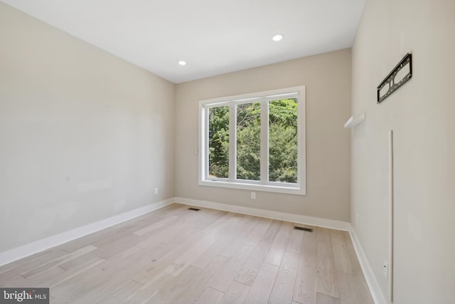 spare room with light hardwood / wood-style flooring