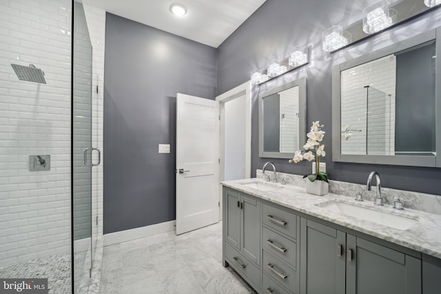 bathroom featuring a shower with door and vanity