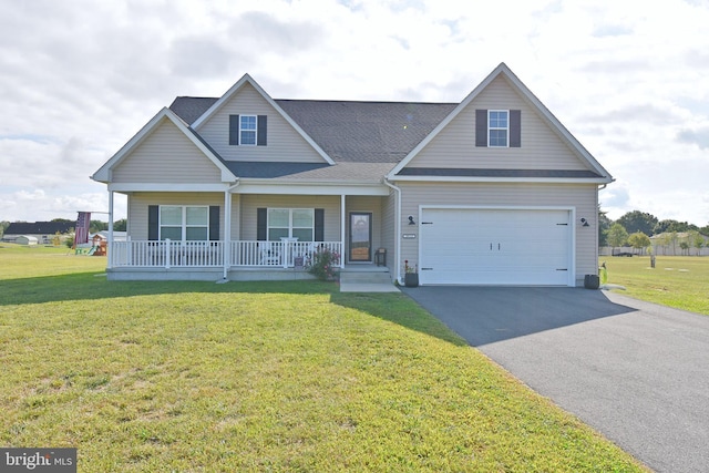 view of front of home with a front yard, a porch, and a garage