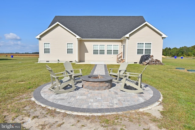 back of property featuring a lawn, an outdoor fire pit, and a patio