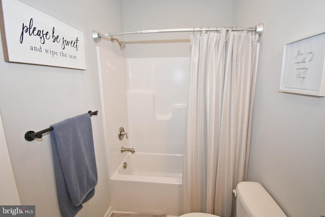 bathroom featuring toilet and shower / tub combo with curtain