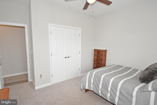 carpeted bedroom with a closet and ceiling fan