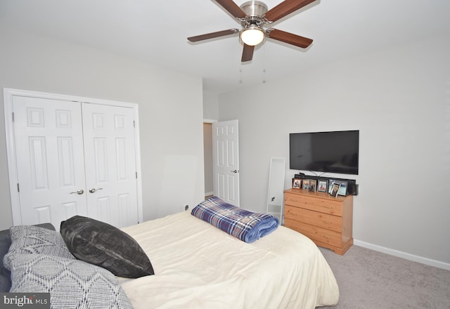 carpeted bedroom with ceiling fan and a closet