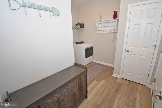 laundry area featuring washer / dryer and light hardwood / wood-style flooring