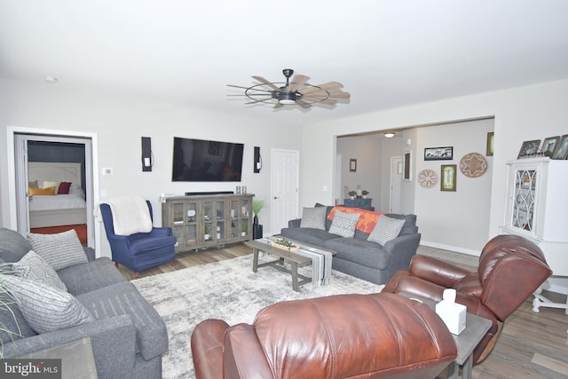 living room featuring hardwood / wood-style flooring and ceiling fan