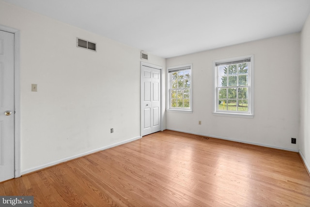 spare room with light hardwood / wood-style flooring