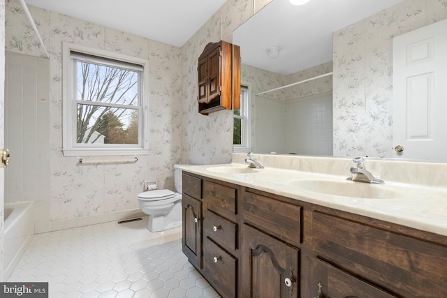 full bathroom with shower / bathing tub combination, tile patterned flooring, vanity, and toilet