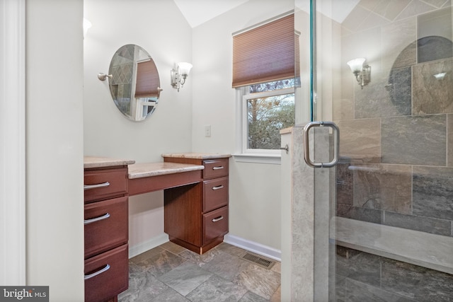 bathroom featuring lofted ceiling and walk in shower