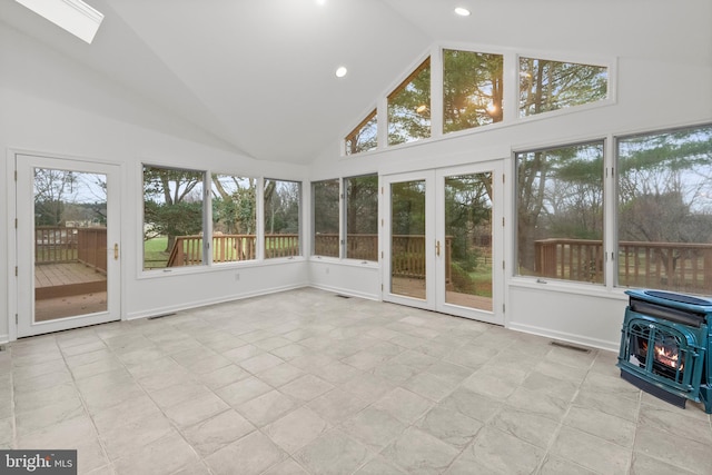 unfurnished sunroom with lofted ceiling with skylight