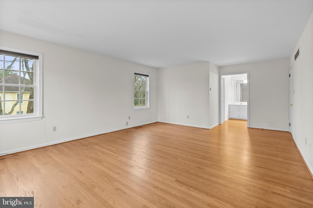 unfurnished room with light wood-type flooring