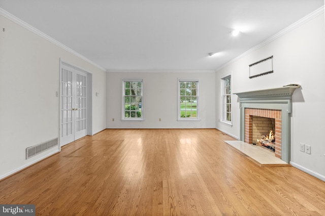 unfurnished living room with a fireplace, light hardwood / wood-style flooring, and crown molding