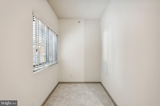 empty room featuring light carpet and plenty of natural light