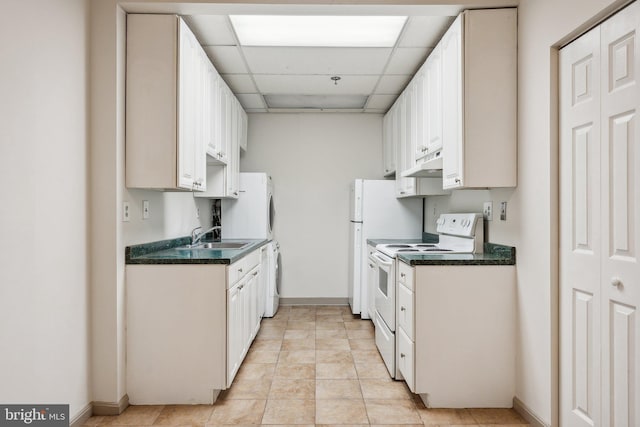 kitchen with sink, a paneled ceiling, white range with electric stovetop, light tile patterned floors, and white cabinets