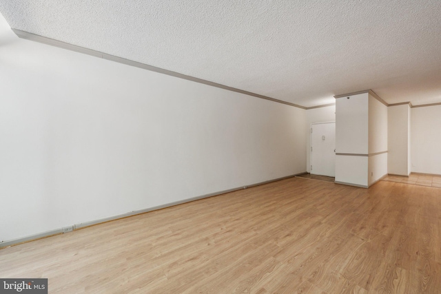 interior space featuring a textured ceiling and light hardwood / wood-style floors