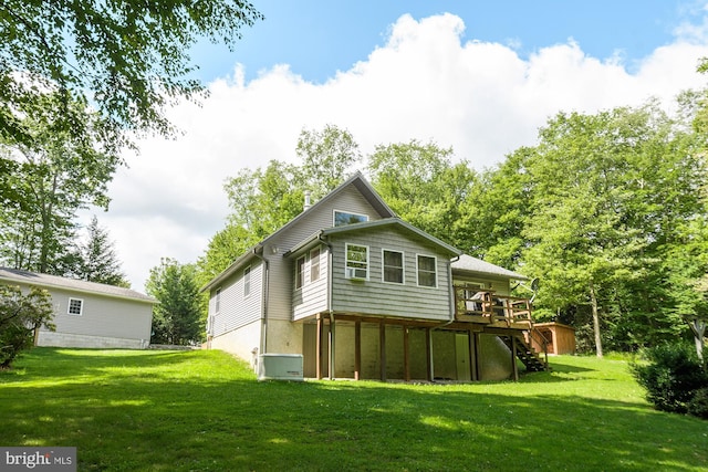 view of side of home featuring a lawn and a deck