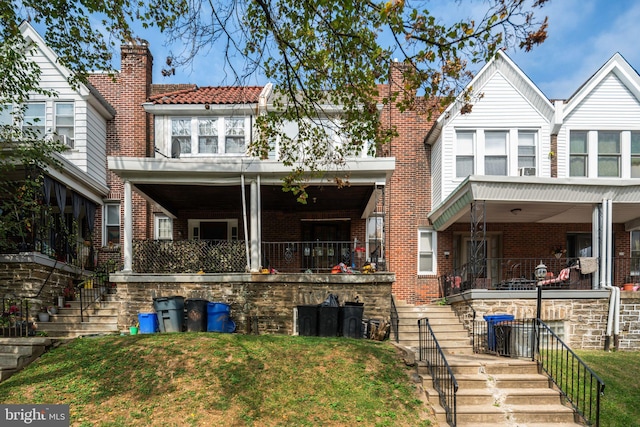 rear view of property with covered porch