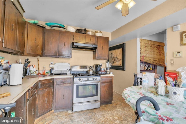 kitchen with stainless steel gas range and ceiling fan