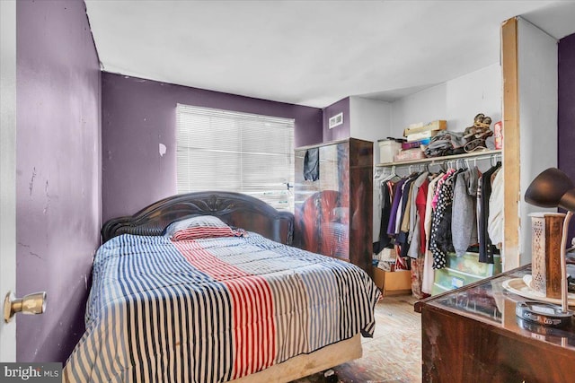 bedroom featuring hardwood / wood-style flooring and a closet