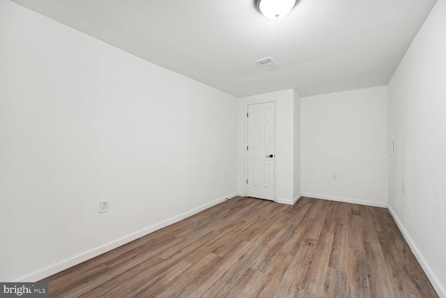 spare room with hardwood / wood-style flooring