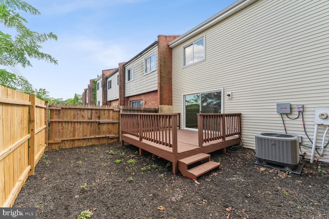 rear view of house with cooling unit and a deck