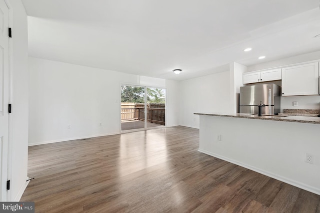 unfurnished living room featuring hardwood / wood-style flooring