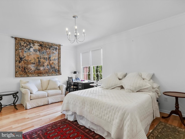 bedroom featuring an inviting chandelier and wood-type flooring