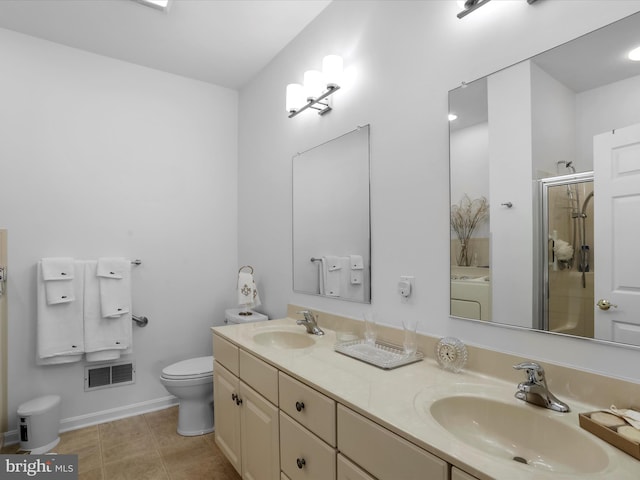 bathroom featuring tile patterned floors, washer / clothes dryer, toilet, vanity, and walk in shower