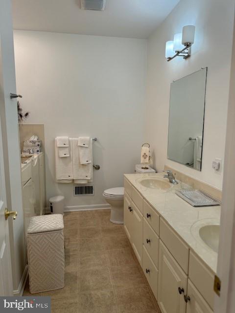 bathroom with toilet and vanity