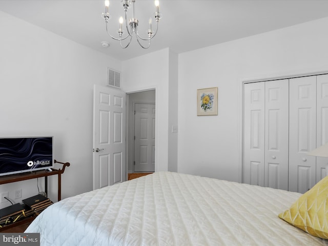 bedroom featuring a closet and a notable chandelier