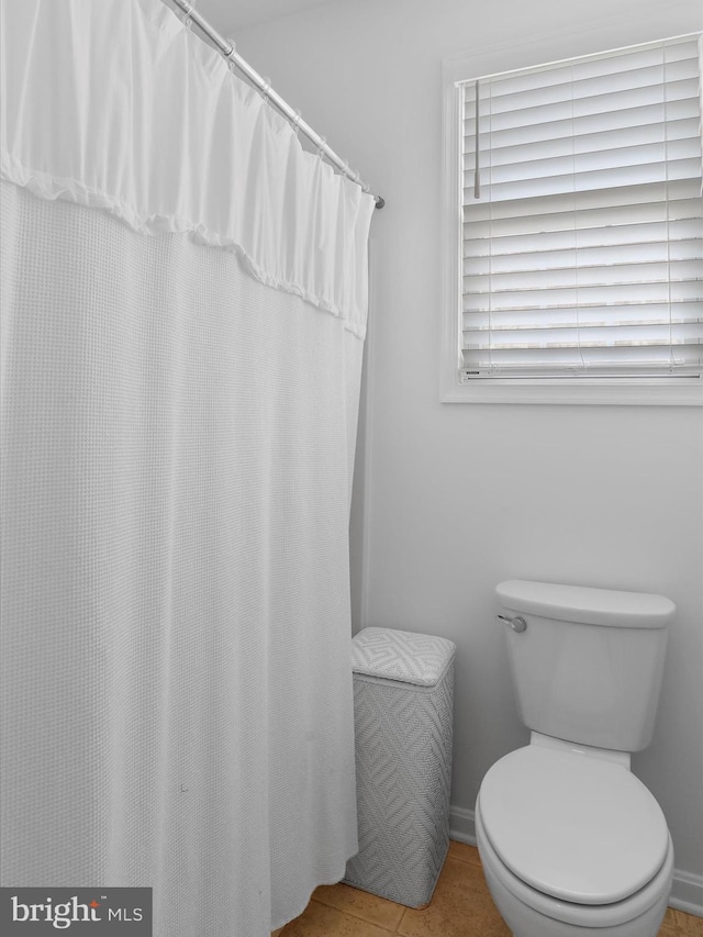 bathroom with tile patterned floors and toilet