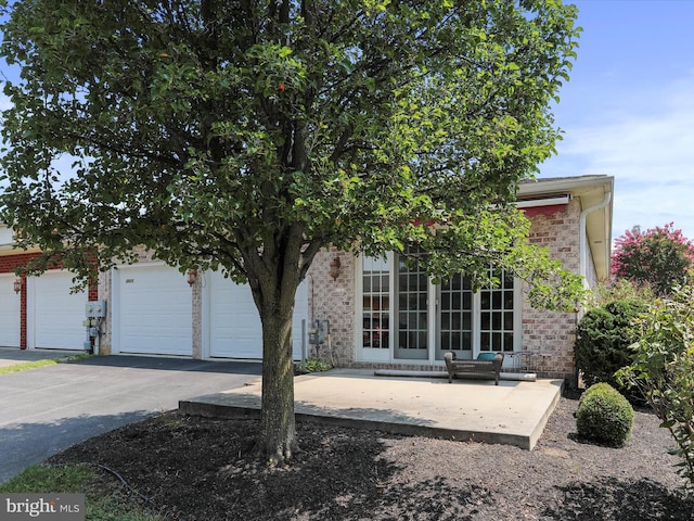 view of front of home with a garage and french doors