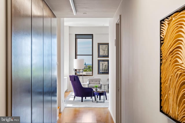 hallway with light hardwood / wood-style flooring