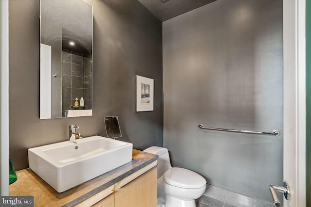 bathroom with vanity, toilet, and tile patterned flooring