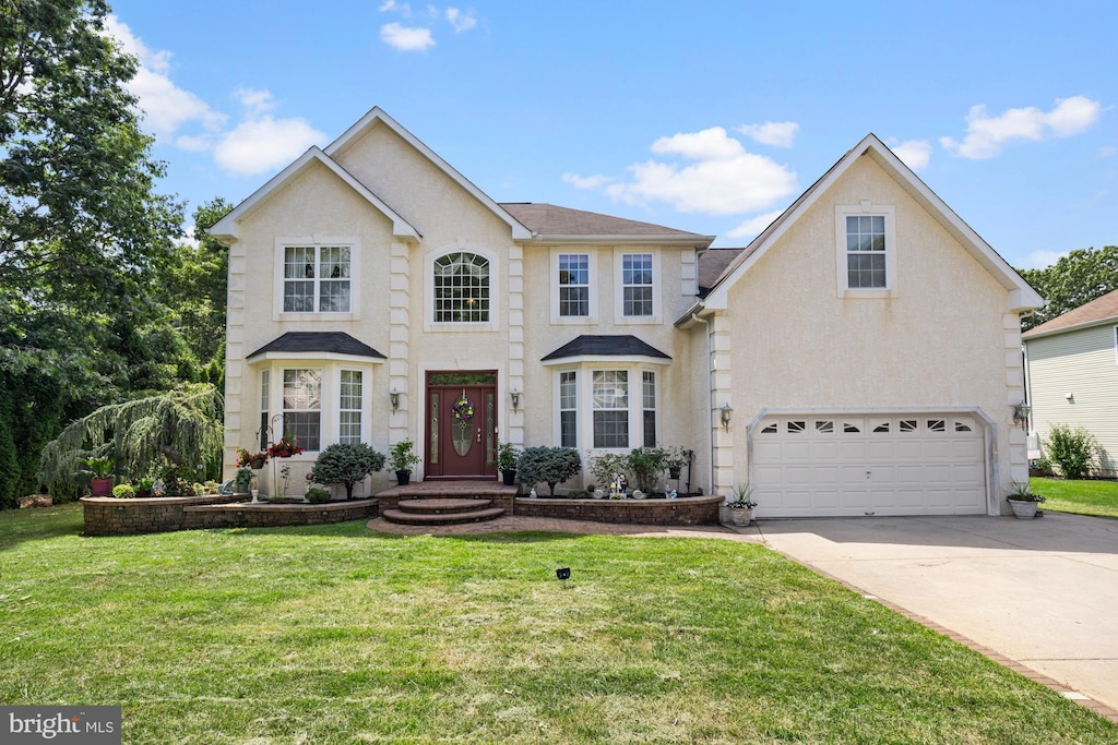 view of front facade featuring a front yard and a garage