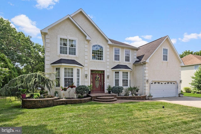 view of front of home with a front lawn and a garage