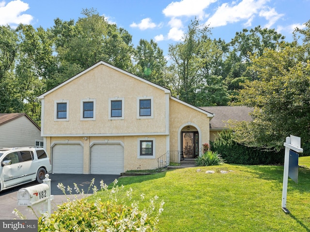 split level home with a front yard and a garage