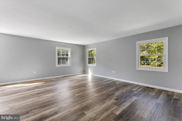 spare room featuring dark hardwood / wood-style flooring