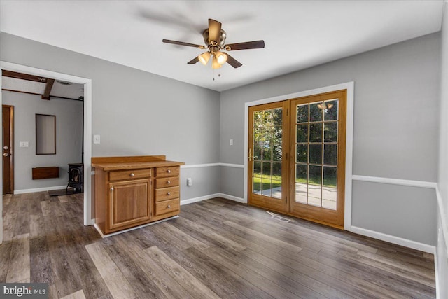 empty room with dark hardwood / wood-style flooring and ceiling fan