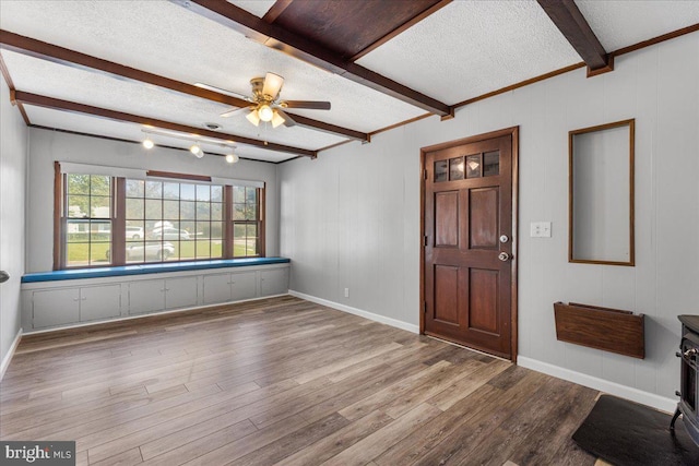 foyer with ceiling fan, beamed ceiling, light hardwood / wood-style floors, and a textured ceiling