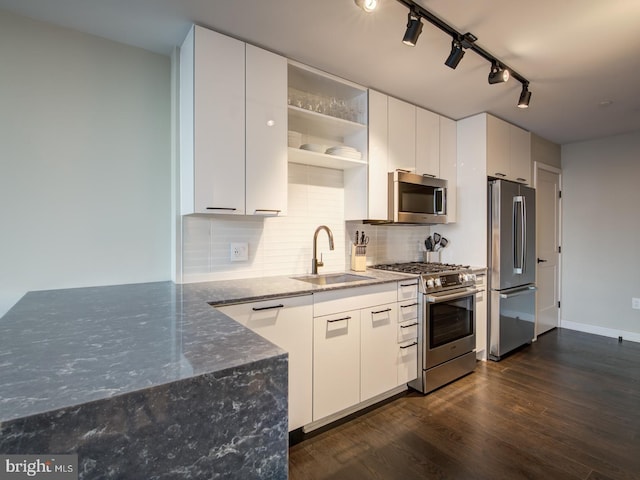 kitchen with sink, appliances with stainless steel finishes, and white cabinets