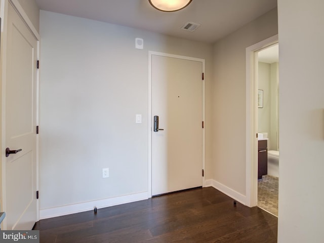 spare room with dark wood-type flooring