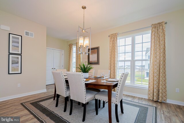 dining room with an inviting chandelier and light hardwood / wood-style floors