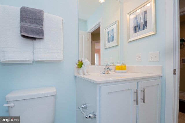 bathroom featuring toilet and vanity